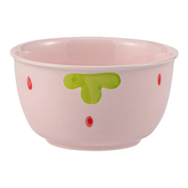 Porcelain dinnerware set with strawberry pattern, showing plates, bowls, and a twist spoon in various sizes