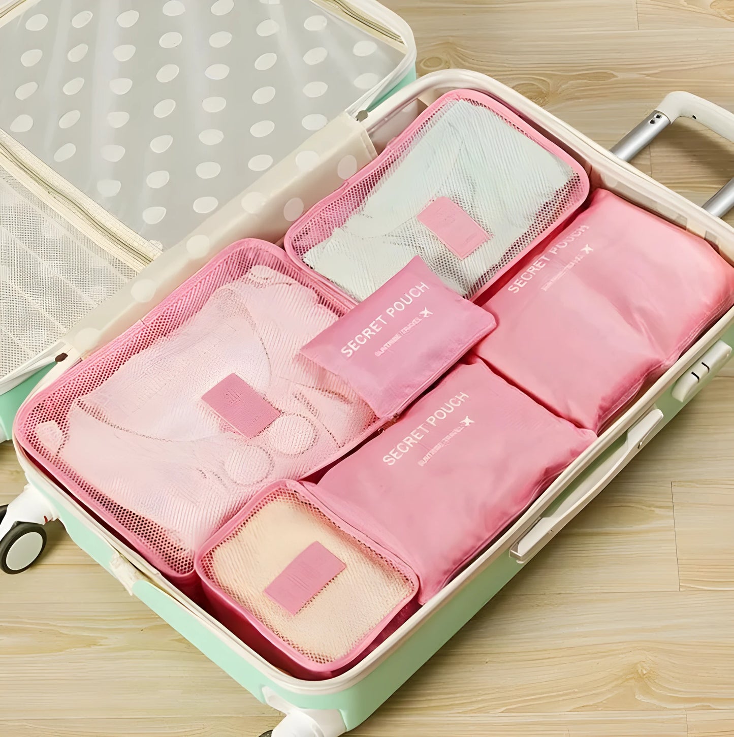Set of six coloured nylon packing cubes and flat pouches for travel organisation.