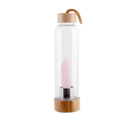 Crystal infused glass water bottle with bamboo lid showing mineral crystal inside 25cm tall container