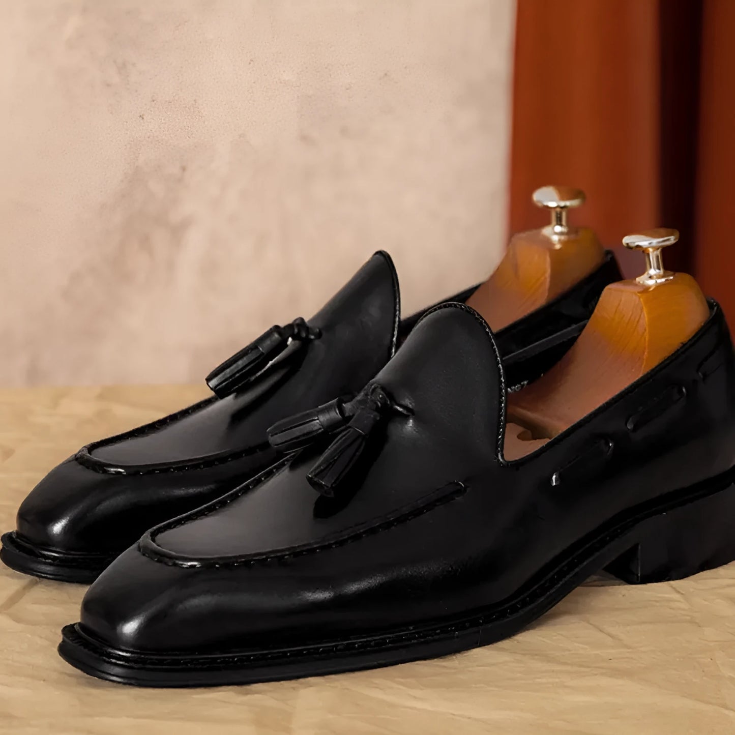 Men's black genuine leather slip-on loafers with polished finish and rubber sole