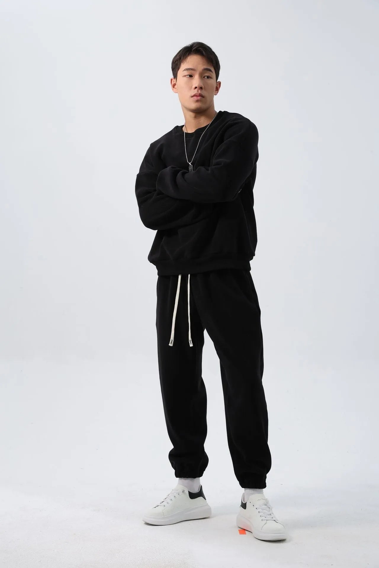 Man wearing a two-piece army green polar fleece suit with crew neck top and padded trousers.