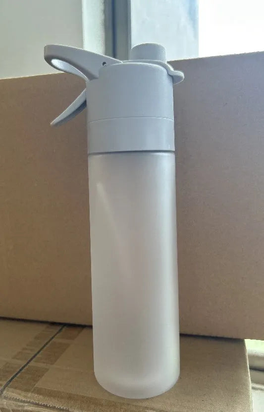Large plastic spray water bottle with handle strap and leakproof lid in green colour.