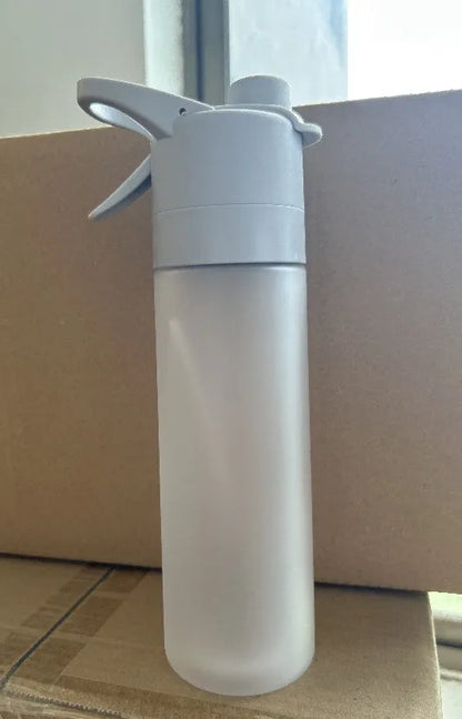 Large plastic spray water bottle with handle strap and leakproof lid in green colour.