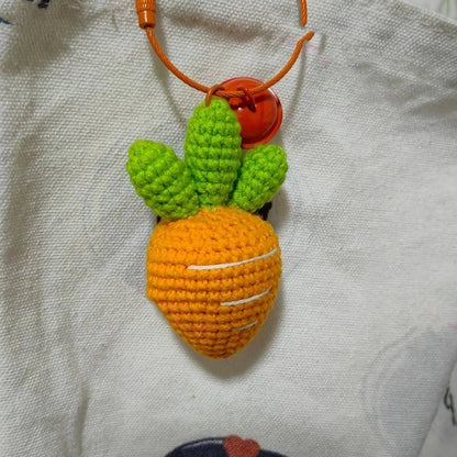 Cartoon carrot car design wool felt keychain pendant on a keyring.