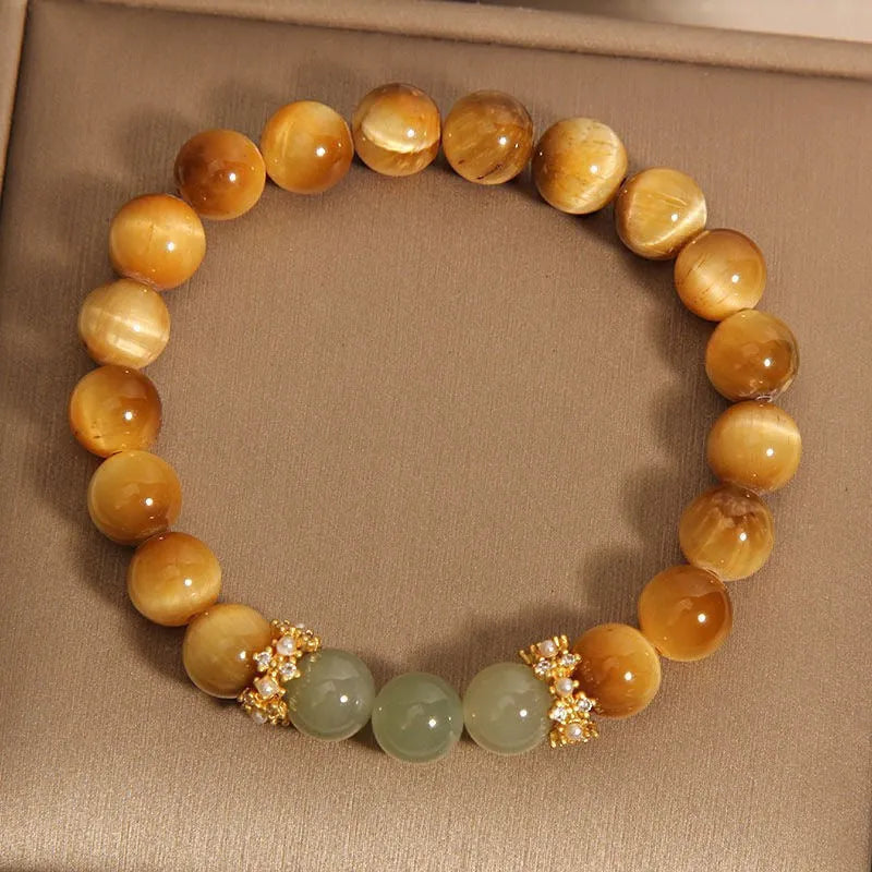 Natural yellow Tiger's Eye bracelet with Hetian jade elements and gold gourd charm on wrist