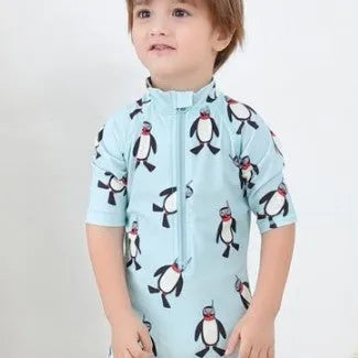 Boy's penguin print long sleeve swimsuit with matching cap for sun protection during water activities