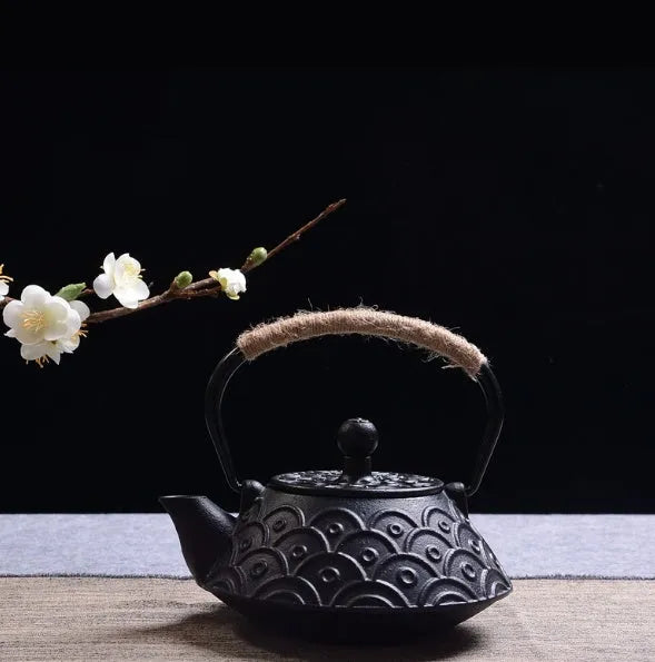 Cast iron teapot, a Japanese-style brewing teapot with a 0.9L capacity, available in classic bronze, fish pattern black, peony, pine needle, raindrop, and wealth-themed finishes for daily tea preparation.
