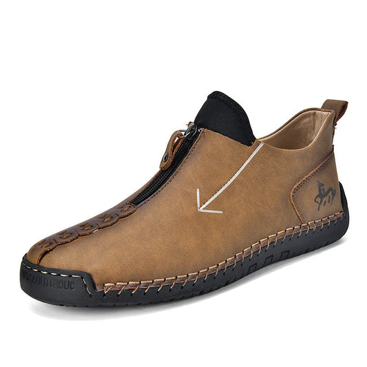 Men's black leather boots with front zipper, hand-stitched detailing, and rubber sole on a neutral background