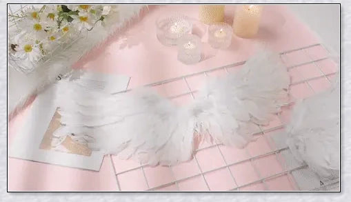 Pair of large, feathered wings in black and white colors, perfect for Halloween costumes and fantasy-themed events.