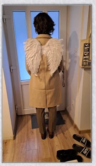 Pair of large, feathered wings in black and white colors, perfect for Halloween costumes and fantasy-themed events.