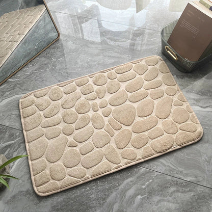 Plush and comfortable memory foam bath mat with cobblestone texture for a soothing, massage-like experience