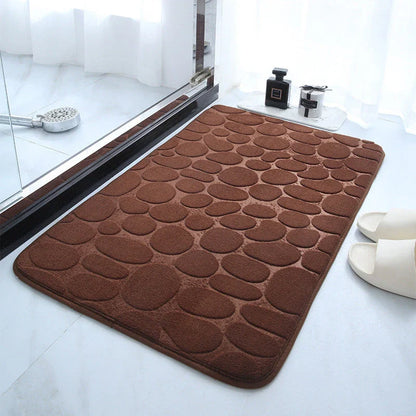 Plush and comfortable memory foam bath mat with cobblestone texture for a soothing, massage-like experience