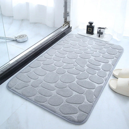 Plush and comfortable memory foam bath mat with cobblestone texture for a soothing, massage-like experience