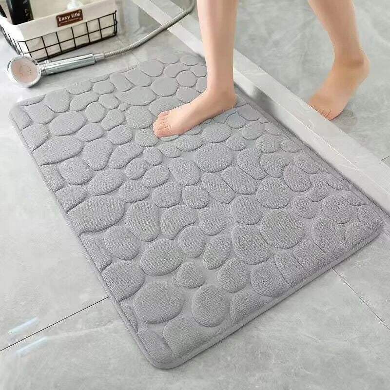 Plush and comfortable memory foam bath mat with cobblestone texture for a soothing, massage-like experience