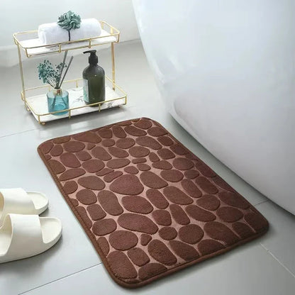 Plush and comfortable memory foam bath mat with cobblestone texture for a soothing, massage-like experience