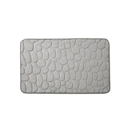 Plush and comfortable memory foam bath mat with cobblestone texture for a soothing, massage-like experience