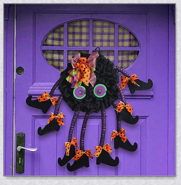 Spiri Halloween Multi-Legged Witch Wreath with orange, purple, and black colors, witch legs, striped boots, and Halloween ribbons