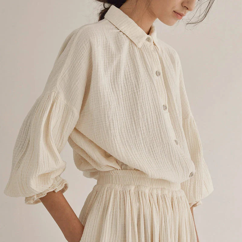 Elegant two-piece set with lantern sleeve shirt and chic skirt, featuring Korean and Japanese fashion influences.