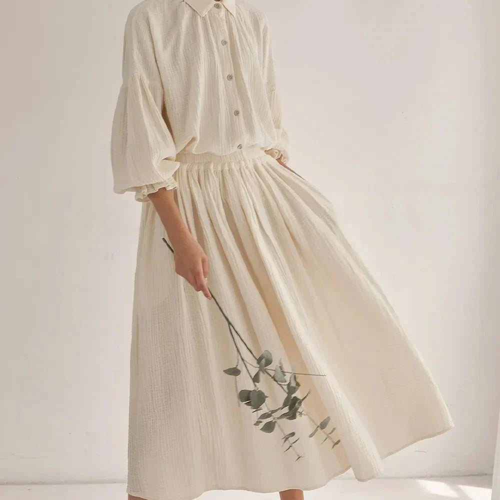 Elegant two-piece set with lantern sleeve shirt and chic skirt, featuring Korean and Japanese fashion influences.