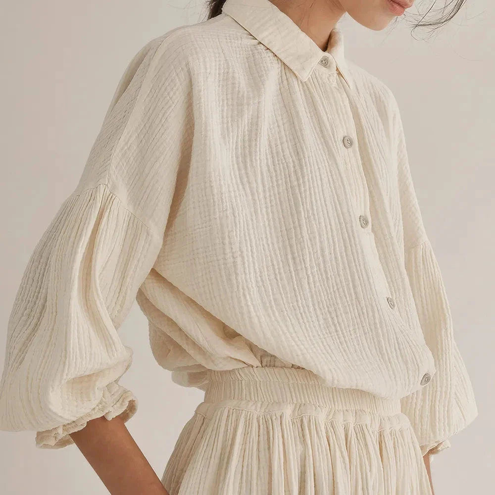 Elegant two-piece set with lantern sleeve shirt and chic skirt, featuring Korean and Japanese fashion influences.