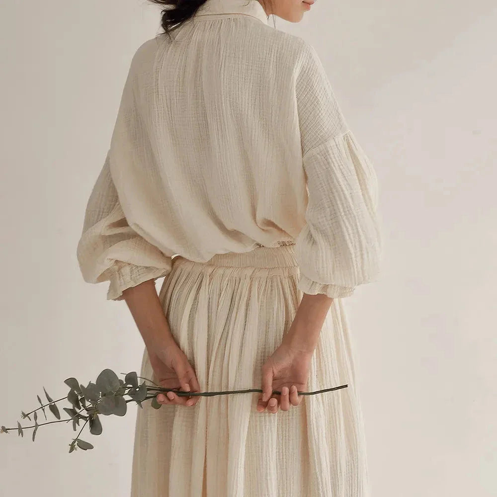 Elegant two-piece set with lantern sleeve shirt and chic skirt, featuring Korean and Japanese fashion influences.