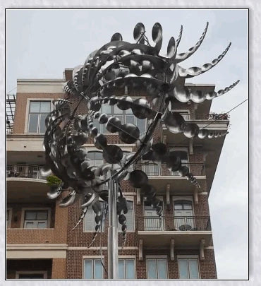 Mesmerizing metal kinetic sculpture with eighteen balanced blades rotating in opposite directions, creating a hypnotic visual display for your outdoor space