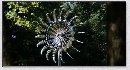 Mesmerizing metal kinetic sculpture with eighteen balanced blades rotating in opposite directions, creating a hypnotic visual display for your outdoor space