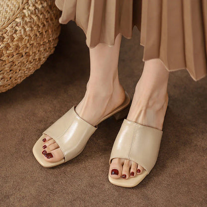 Elegant women's sandals with a thick, stable heel and open-toe design in a neutral beige color