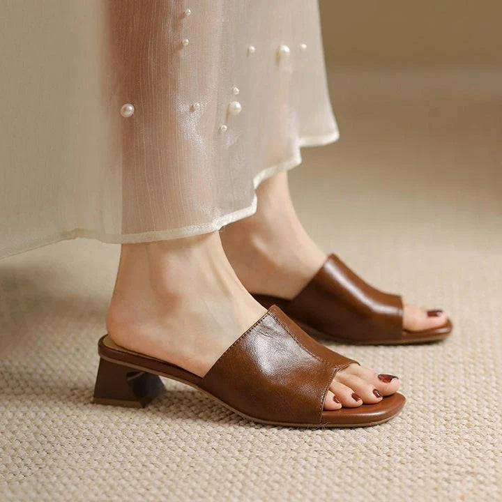 Elegant women's sandals with a thick, stable heel and open-toe design in a neutral beige color