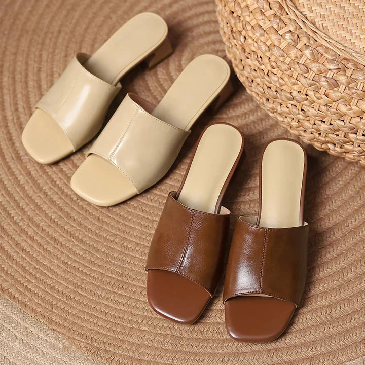 Elegant women's sandals with a thick, stable heel and open-toe design in a neutral beige color