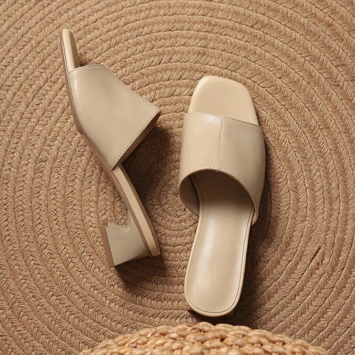 Elegant women's sandals with a thick, stable heel and open-toe design in a neutral beige color