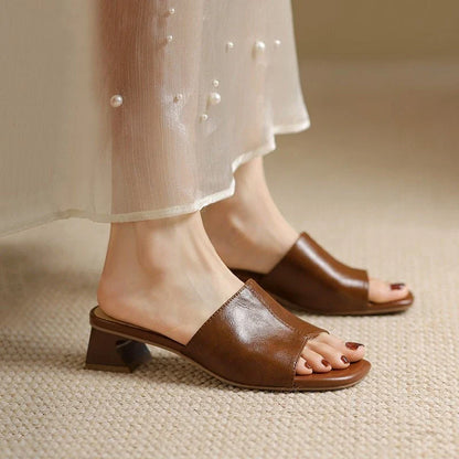 Elegant women's sandals with a thick, stable heel and open-toe design in a neutral beige color
