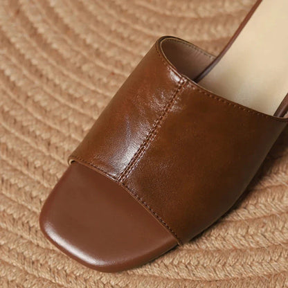 Elegant women's sandals with a thick, stable heel and open-toe design in a neutral beige color