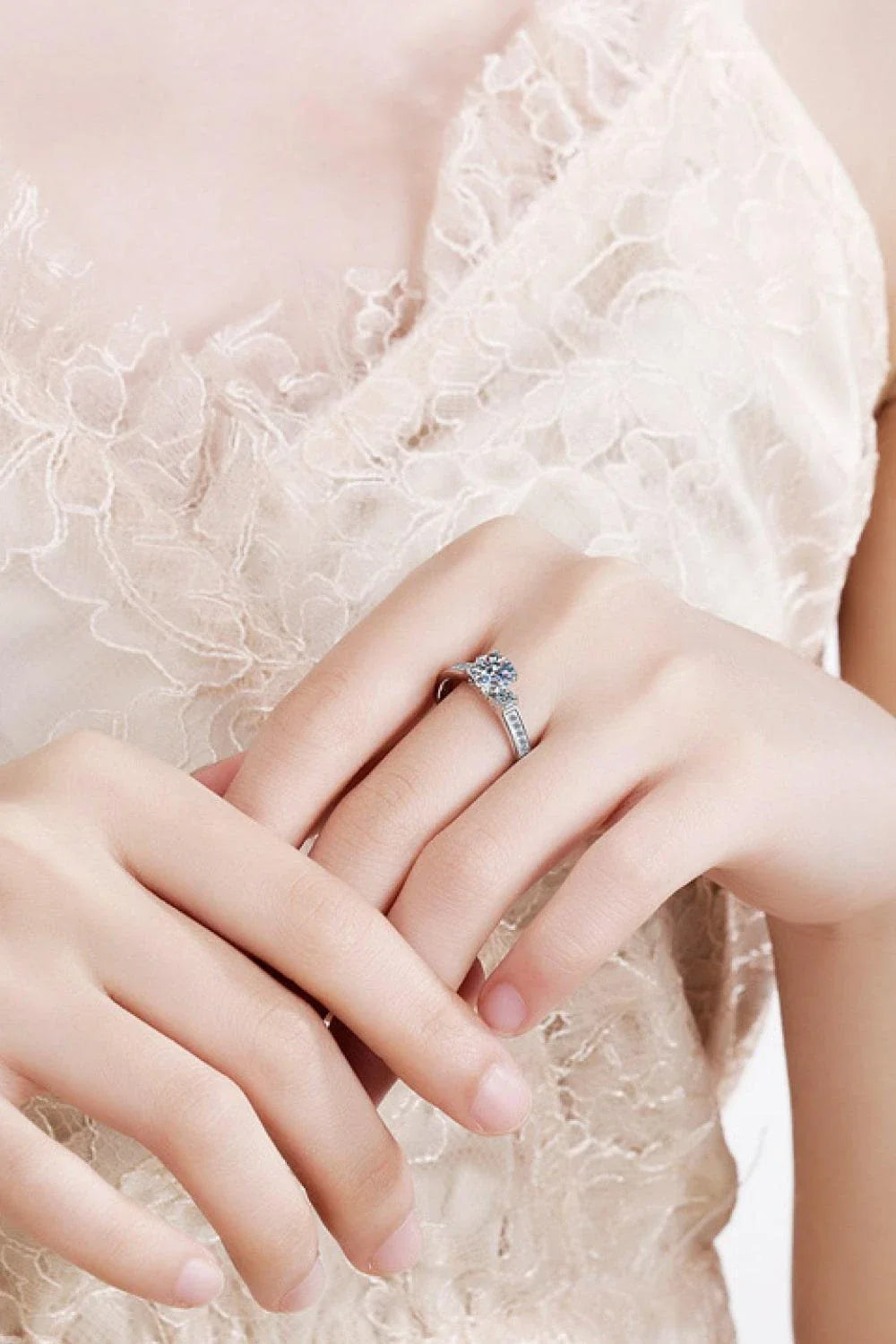 Closeup shot of a sparkling moissanite ring with a rhodium-plated silver band and subtle zircon accent stones