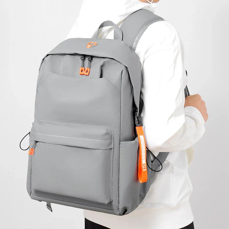 Men's simple casual travel laptop bag in grey color, featuring adjustable shoulder straps and a durable polyester lining