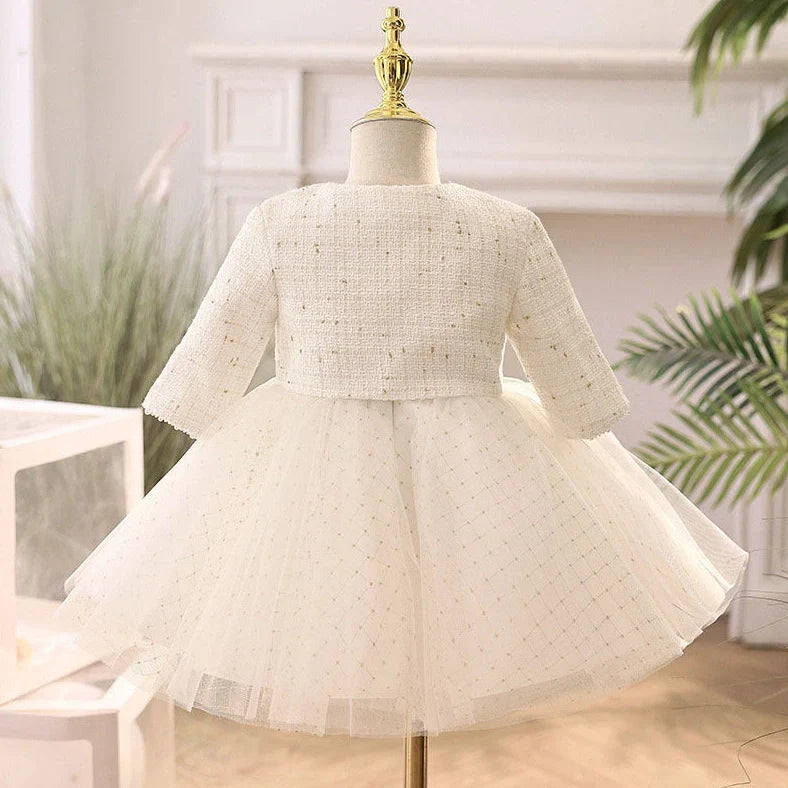 White long-sleeved flower girl wedding dress with princess styling on mannequin