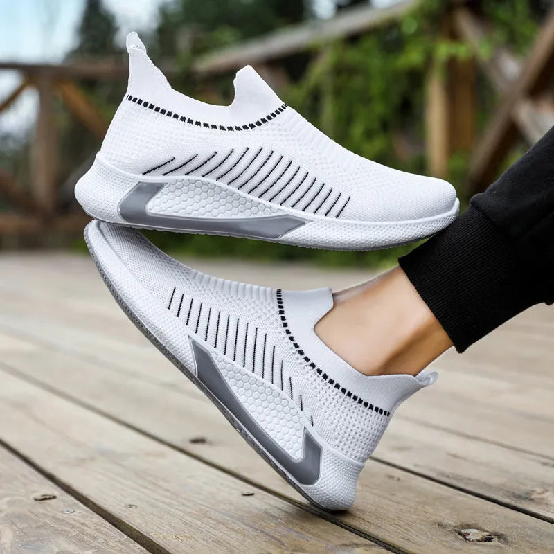 Men's mesh sock slip-on sneakers with a striped design, lightweight flyknit upper, breathable mesh lining, low-top round-toe profile, front lace-up closure, injection-moulded plastic sole, and colour-blocking detail for outdoor casual wear and running.
