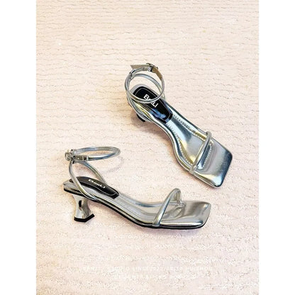 Black women's high heel sandals with a single ankle strap, square toe, and thick heel.