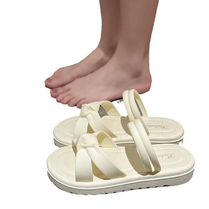 Women's black PVC sandals with thick soft back, floral detail, and injection moulded sole