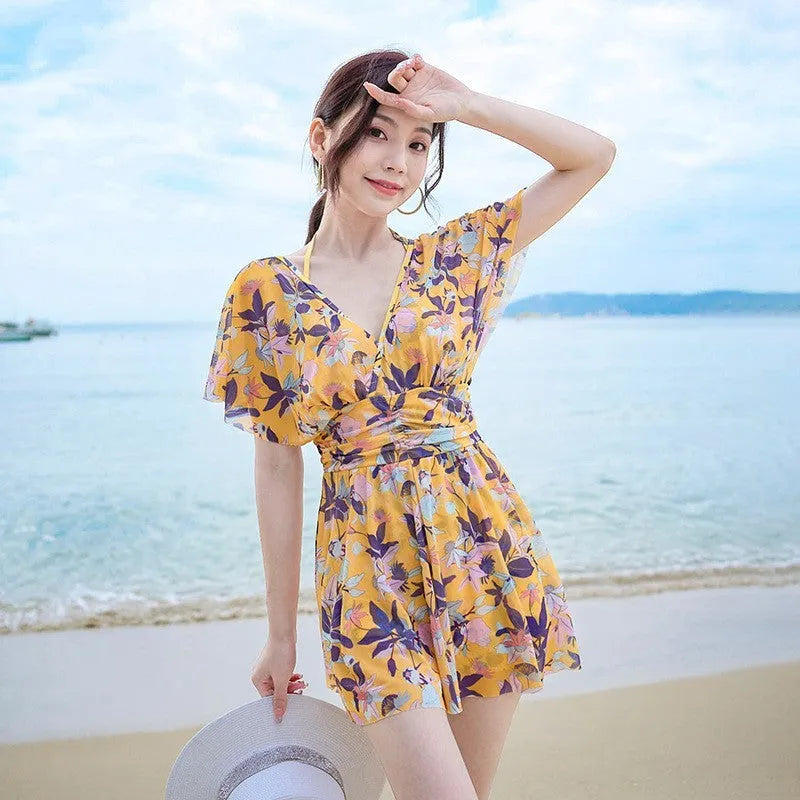 Yellow floral pattern women's one-piece swimsuit on hanger