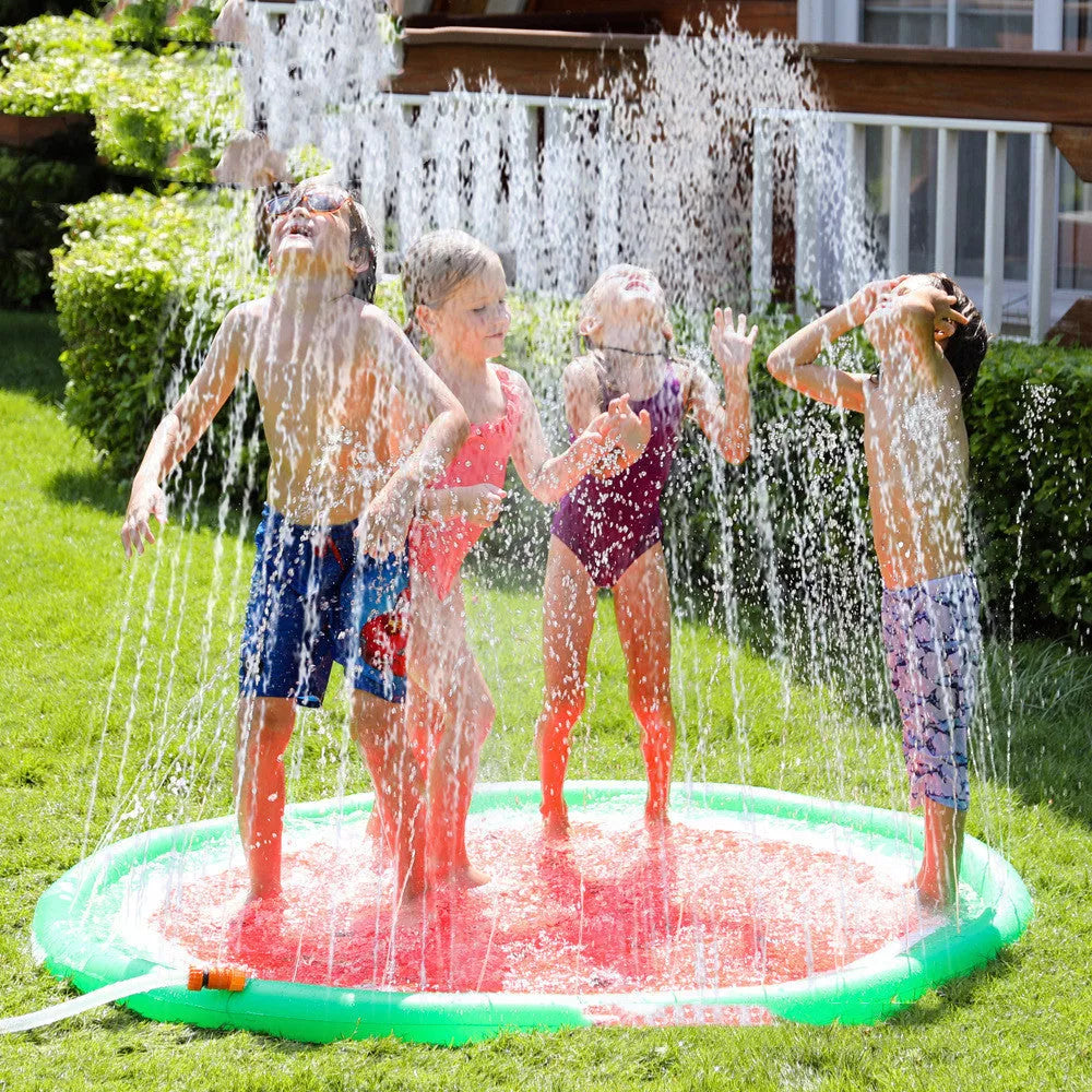 Children playing on a vibrant watermelon design water spray mat outdoors