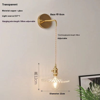 Retro brass lotus wall lamp with copper body and glass shade in various colours, mounted on a wall