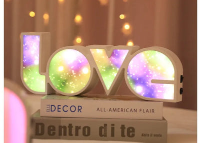 Rainbow halo LED love light with 'LOVE' word decoration on plastic casing.