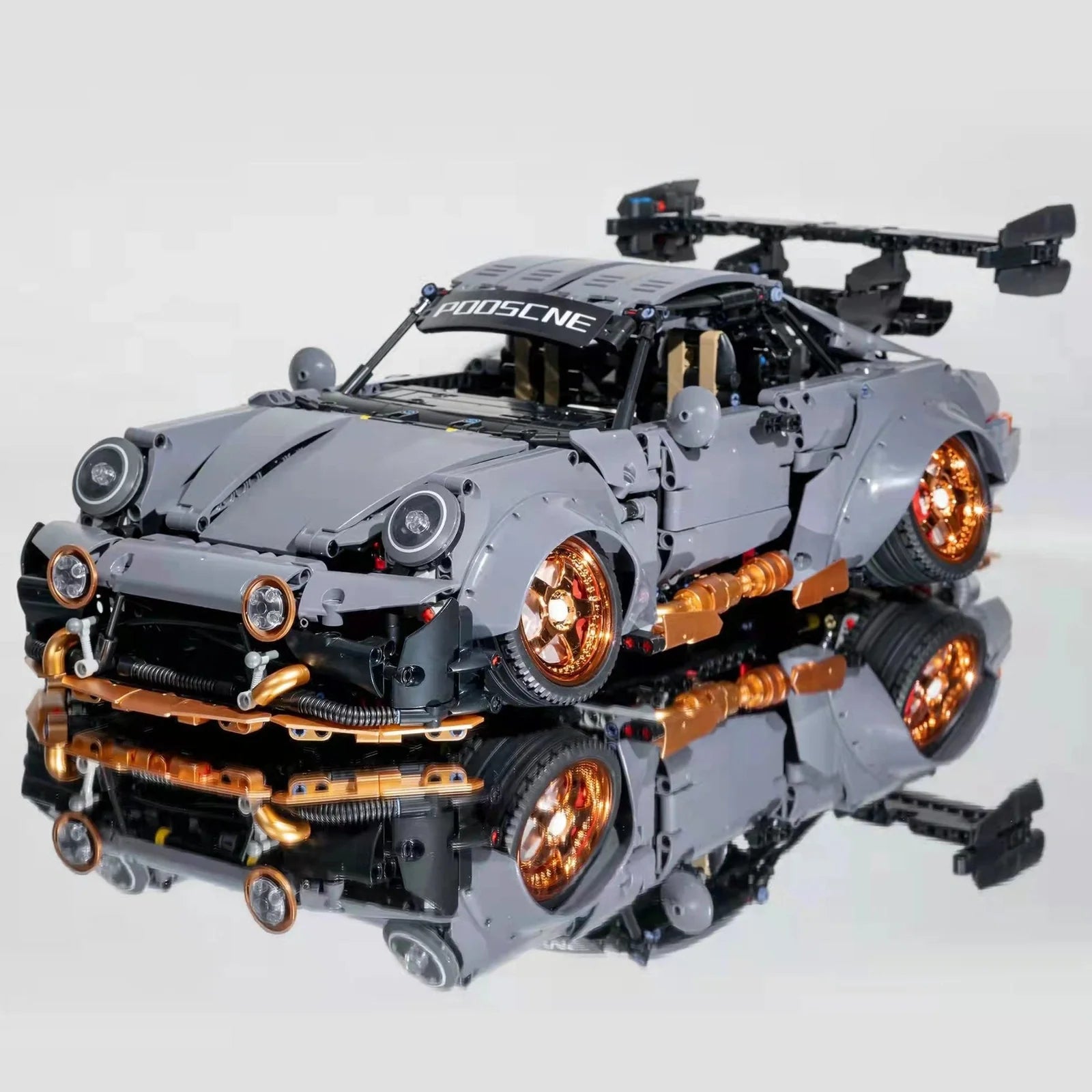 Cement grey Porsche sports car building block set with 10220 pieces showing detailed assembly components