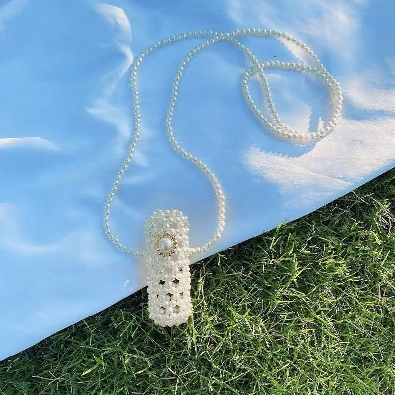Women's imitation pearl mini crossbody handbag with geometric pattern in a pearl colour.