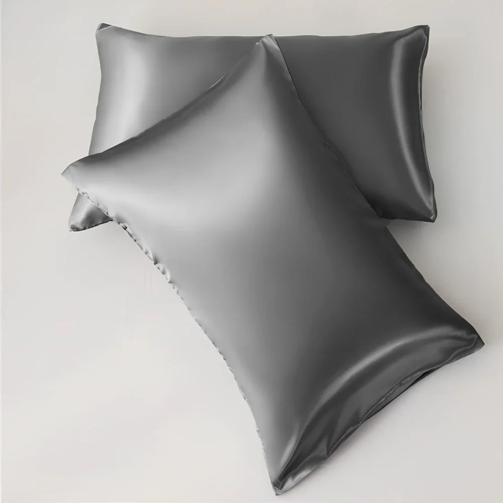 Silk-effect satin envelope pillowcase in navy blue showing envelope closure and smooth fabric texture