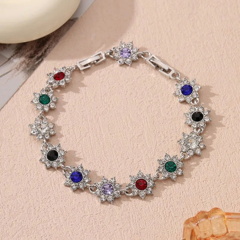Floral shaped zinc alloy bracelet with electroplated colourful gem finishes in gold and silver tones.