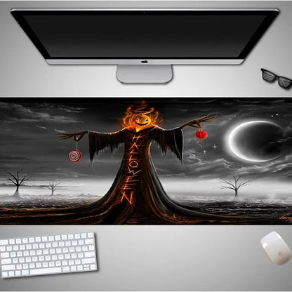 Oversized black Halloween-themed mouse pad with graphic design on a wooden desk, showing non-slip rubber base.