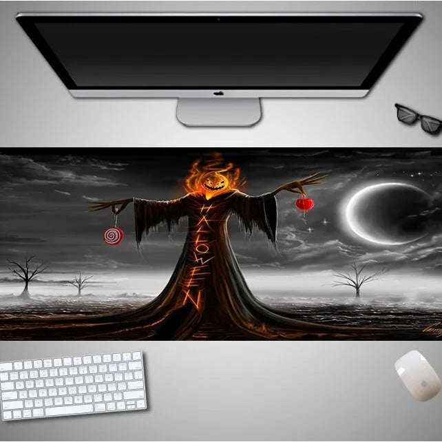 Oversized black Halloween-themed mouse pad with graphic design on a desk with keyboard and mouse