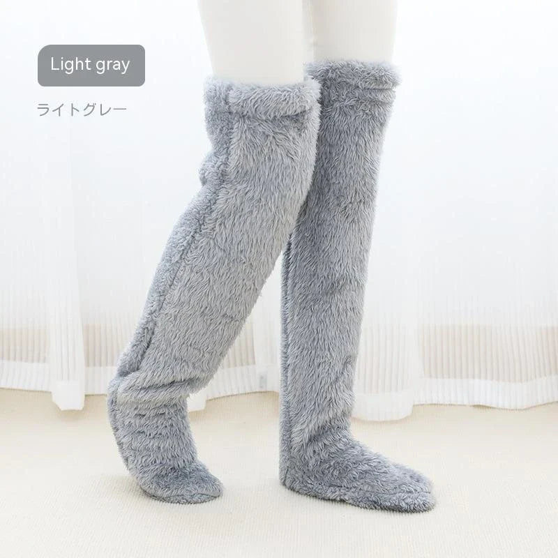 Cozy over-the-knee fuzzy socks in various colors, including brown, blue, dark gray, pink, silver, and more. Comfortable cotton design for warm, snug legs.